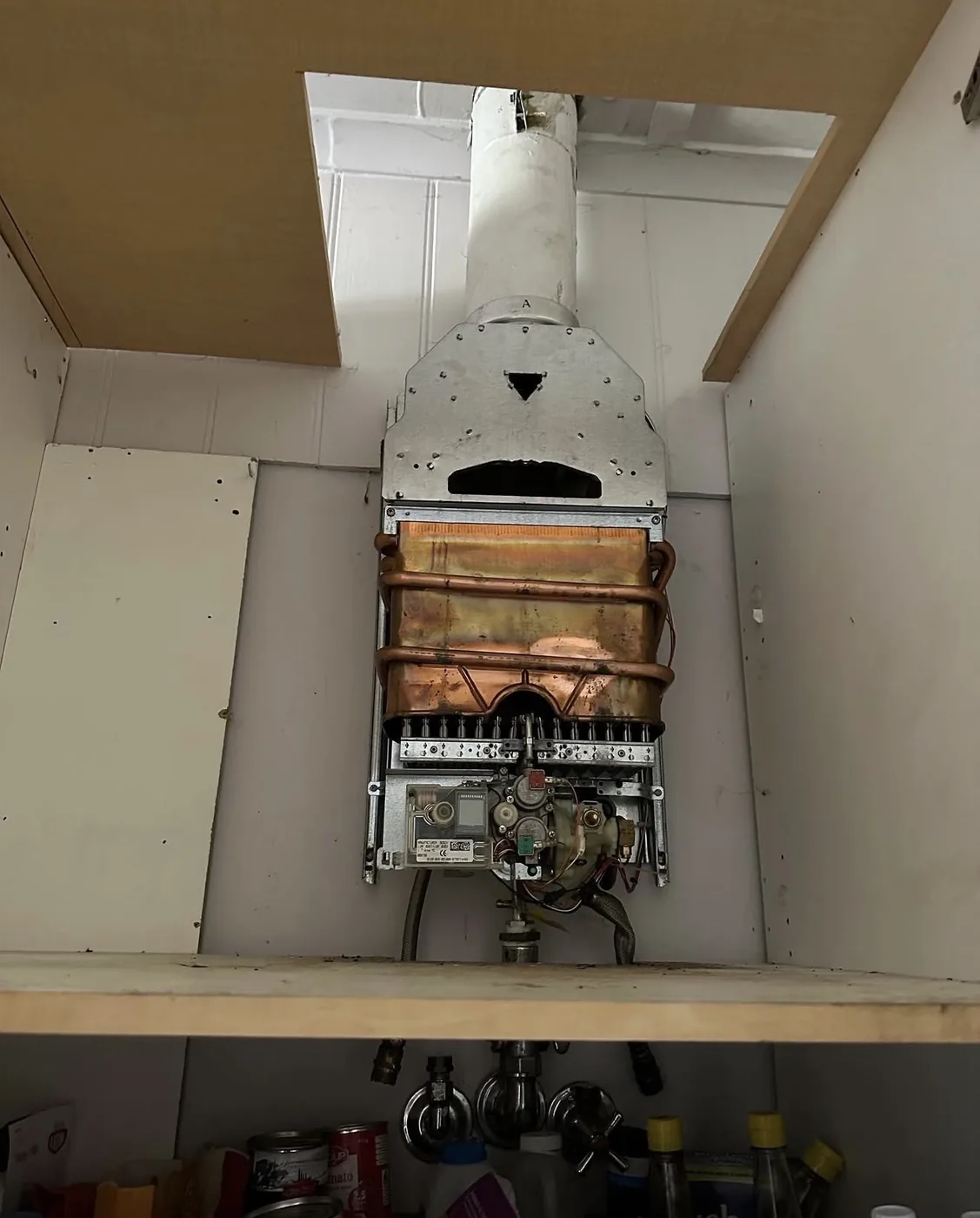 Old internal hot water unit before replacement